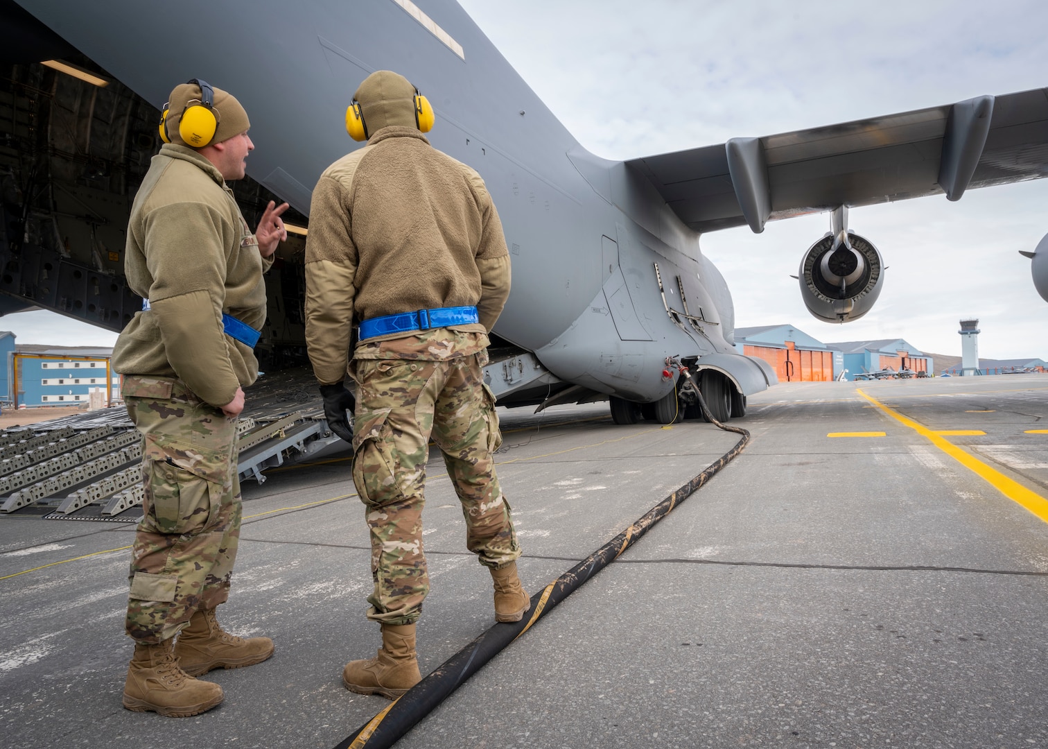 U.S. Air Force Airmen assigned to the 140th Wing and 4th Airlift Squadron preform a wet-wing defuel during exercise Amalgam Dart 21-01, June 16, 2021 at Thule Air Base, Greenland.