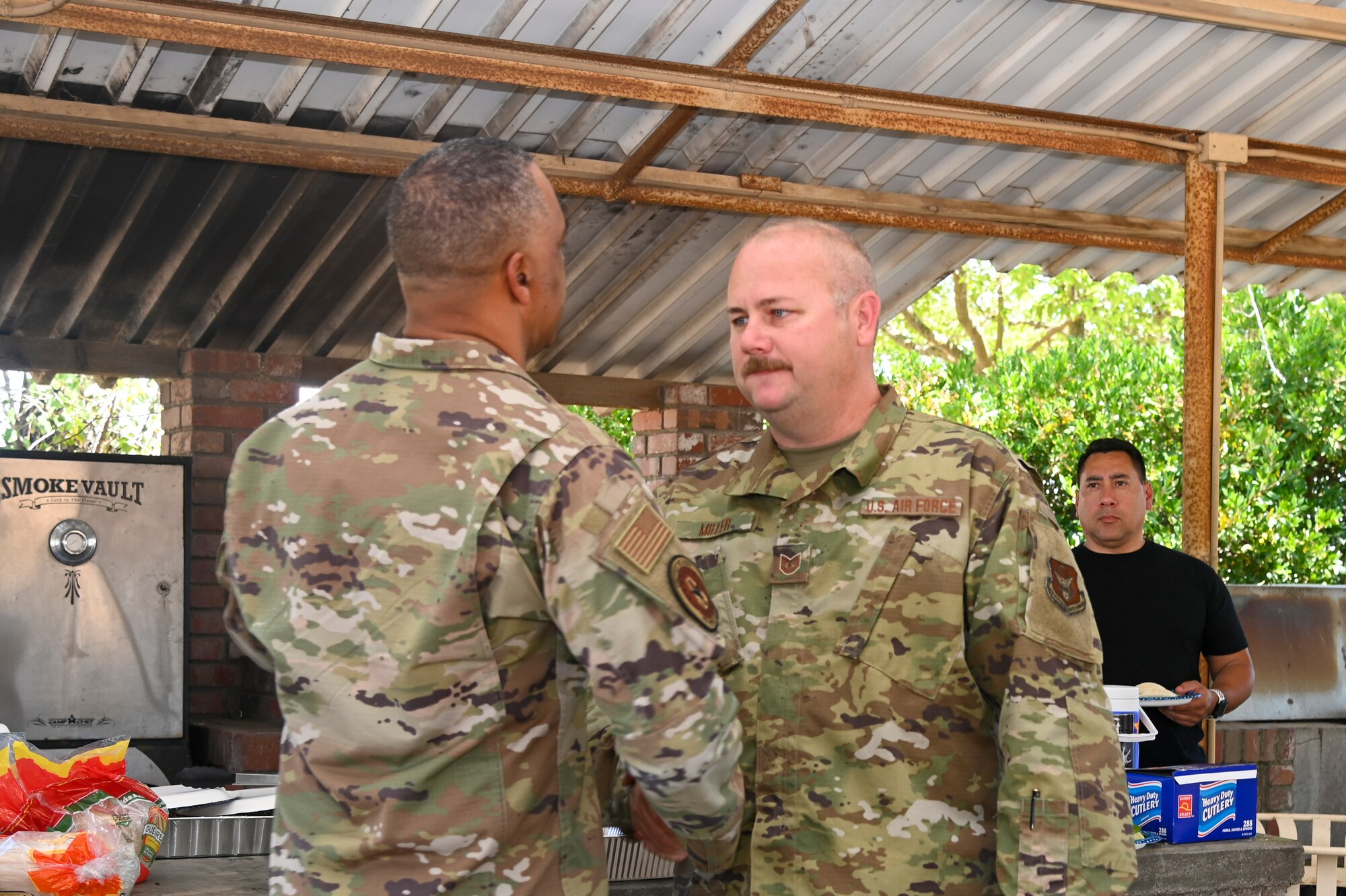 Chief Master Sgt. Timothy C. White Jr., command chief master sergeant, Air Force Reserve Command, Robins Air Force Base, Georgia, shakes hands with Tech. Sgt. Matt Miller, 940th Maintenance Squadron crew chief, June 12, 2021, at Beale AFB, California.