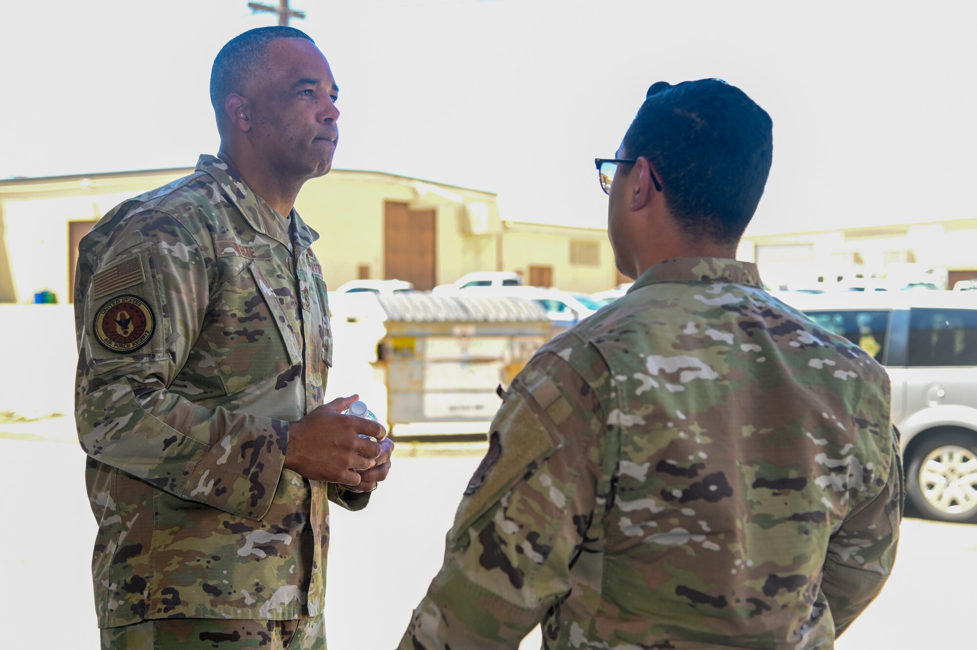 Chief Master Sgt. Timothy C. White Jr., command chief master sergeant, Air Force Reserve Command, Robins Air Force Base, Georgia, listens to Tech. Sgt. Francisco Jimenez, 940th Aircraft Maintenance Squadron aircraft pneudraulics, Beale AFB, California June 12, 2021, at Beale AFB, California.