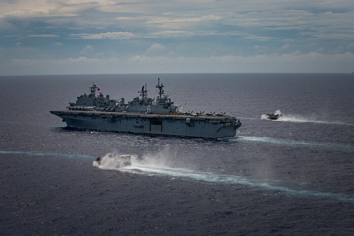 The amphibious assault ship USS America (LHA 6) sails in formation with landing craft, air cushions assigned to the Japan Maritime Self-Defense Force during a bilateral exercise in the Philippine Sea, June 13, 2021. Bilateral exercises further demonstrate command control and interoperability between allies ultimately enhancing future operations. The 31st Marine Expeditionary Unit is operating aboard ships of the America Amphibious Ready Group in the 7th Fleet area of operations to enhance interoperability with allies and partners and serve as a ready response force to defend peace and stability in the Indo-Pacific region.