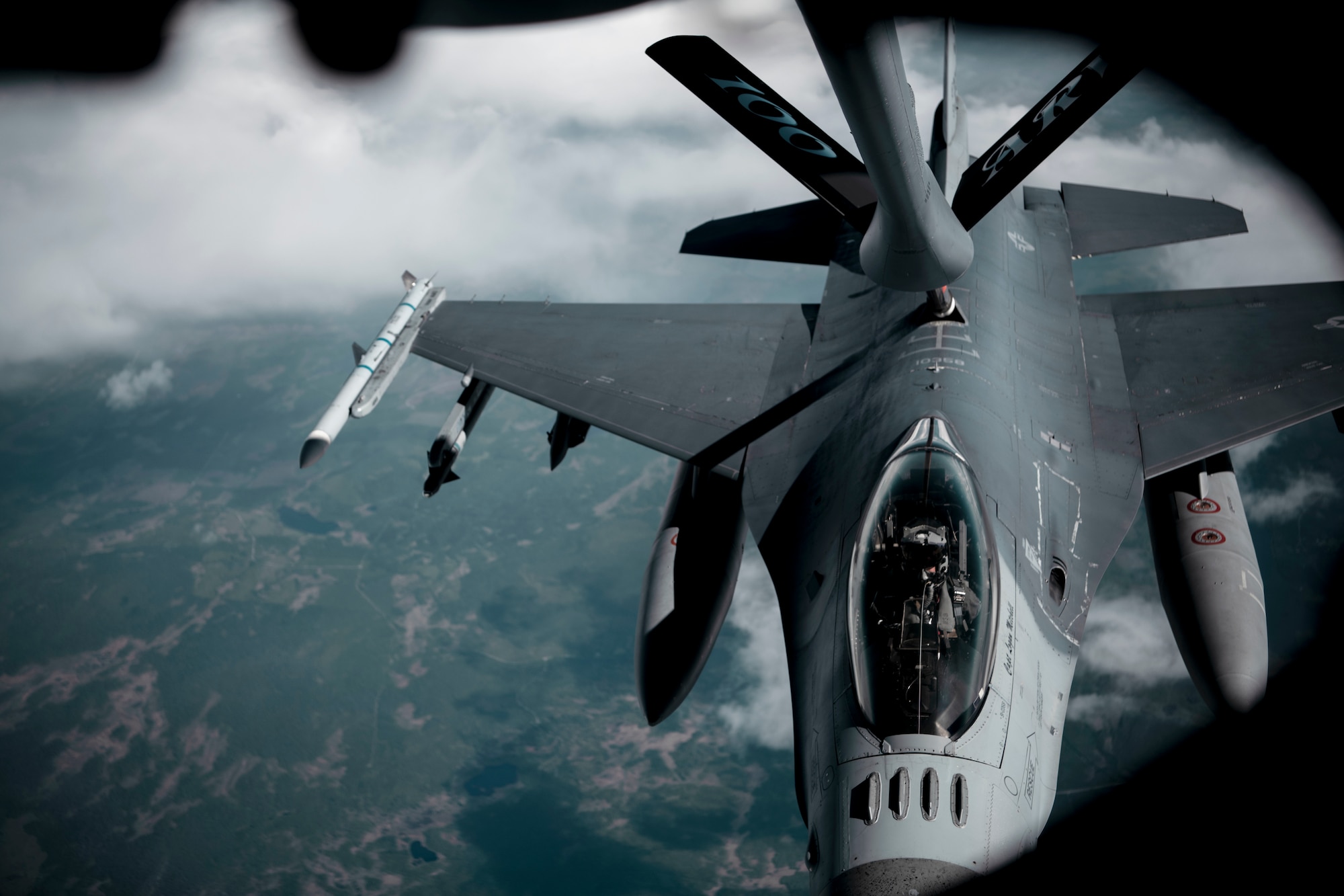 A U.S. Air Force KC-135 Stratotanker aircraft assigned to the 100th Air Refueling Wing at Royal Air Force Mildenhall, England, provides fuel to an F-16 Fighting Falcon aircraft assigned to the 52d Fighter Wing, Spangdahlem Air Base, Germany, above Sweden, June 15, 2021. The 100th ARW provided air refueling support to the Arctic Challenge Exercise, June 1-18. (U.S. Air Force photo by Senior Airman Antonia Herrera)