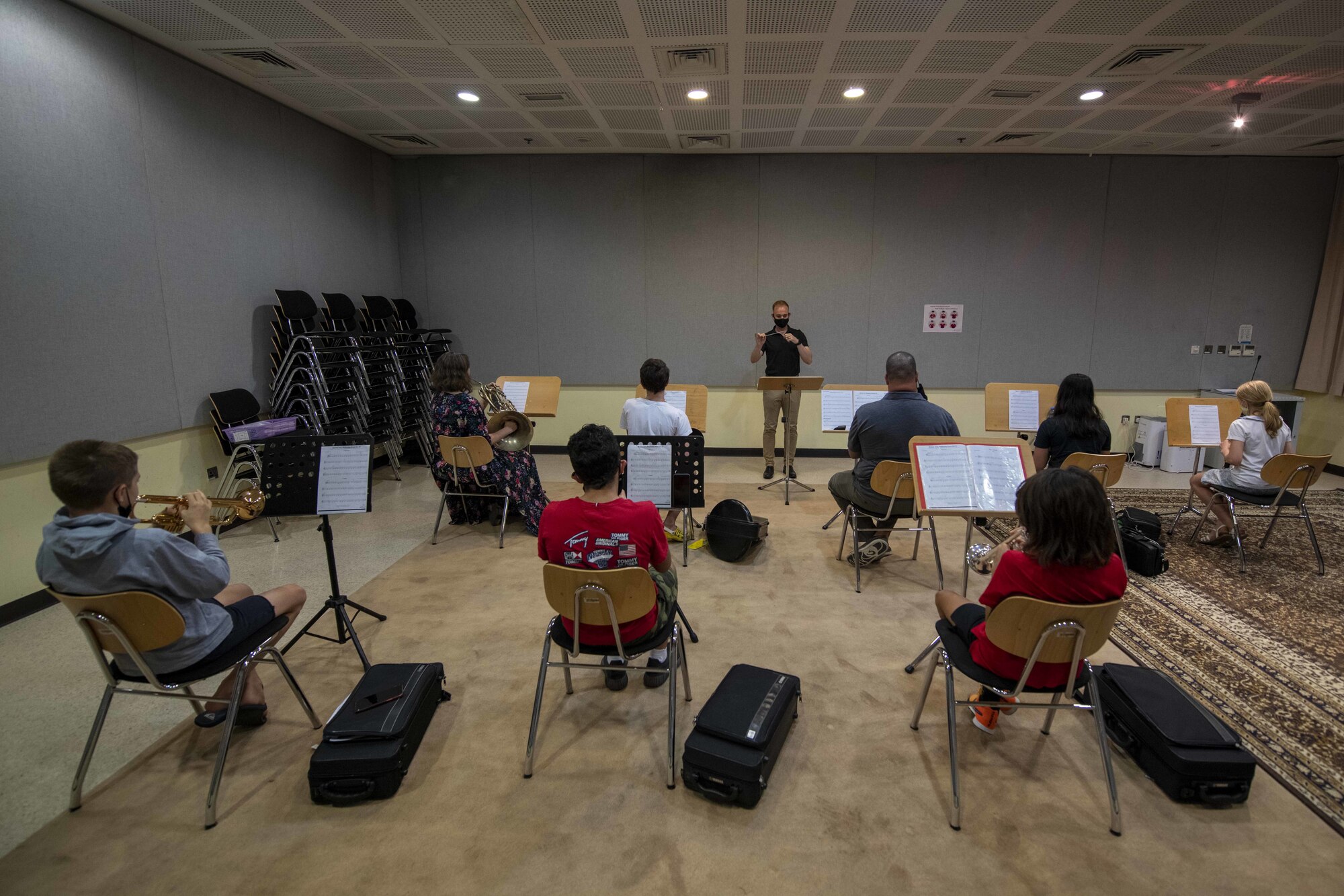 U.S. Air Force 1st Lt. Brandon Hults, AFCENT Band officer in charge, conducts students from the Junior Symphonic Winds at the Qatar Music Academy, June 15, 2021, Doha, Qatar.  Members of the AFCENT Band worked with students during class and played alongside them during rehearsal. The AFCENT Band uses community engagement opportunities like school visits to share the Air Force mission through music. (U.S. Air Force photo by Tech. Sgt. Dylan Nuckolls)