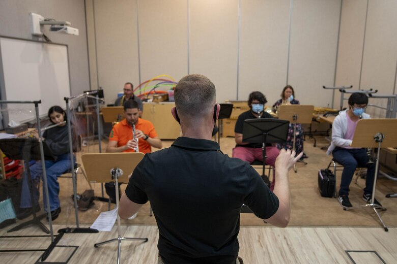 U.S. Air Force 1st Lt. Brandon Hults, AFCENT Band officer in charge, instructs wind players from the Qatar Youth Orchestra at the Qatar Music Academy, June 15, 2021, Doha, Qatar.  Members of the AFCENT Band worked with students during class and played alongside them during rehearsal. The AFCENT Band uses community engagement opportunities like school visits to share the Air Force mission through music. (U.S. Air Force photo by Tech. Sgt. Dylan Nuckolls)