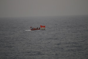 210616-N-NO748-1052 GULF OF ADEN (June 16, 2021) Sailors assigned to Embarked Security  Intelligence Team 11, deployed with Commander, Task Force (CTF) 56 and Merchant Mariners from the Military Sealift Command fleet replenishment oiler USNS Patuxent (T-AO 201), embark mariners from a vessel in distress during rescue operations in the Gulf of Aden, June 16. Patuxent is deployed to the U.S. 5th Fleet area of operations in support of naval operations to ensure maritime stability and security in the Central Region, connecting the Mediterranean and Pacific through the Western Indian Ocean and three strategic choke points. (U.S. Navy photo)