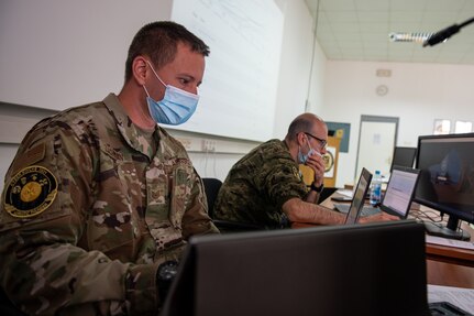 U.S. Air Force Tech Sgt. Jared Zachman, a cyber analyst with Minnesota National Guard Joint Force Headquarters Defensive Cyber Operations Element, works alongside Croatian Armed Forces service member 2nd Lt. Domagoj Volarevic during cyber training prior to the start of the joint cyber training exercise, Midwest Croatia Kosovo Exercise Adriatic Thunder at Dr. Franjo Tudman Croatian Military Academy, Zagreb, Croatia, on June 14, 2021.