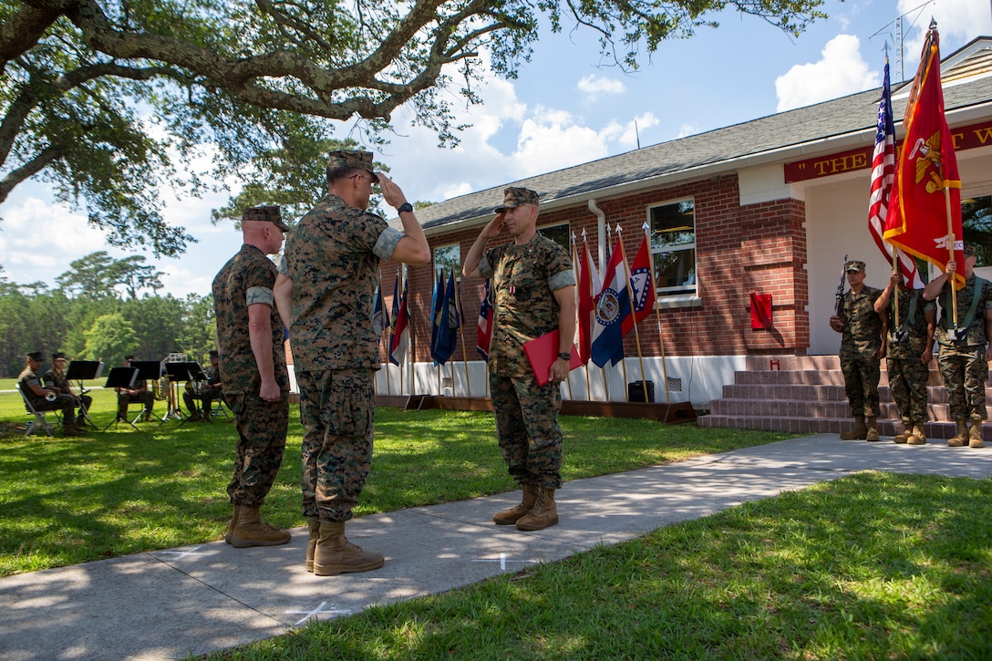 U.S. Marine Corps Lt. Col. Lynn W. Berendsen, right, the outgoing commanding officer of 2d Assault Amphibian Battalion, 2d Marine Division, is awarded the Meritorious Service Medal by Maj. Gen. Francis Donovan, left, the commanding general of 2d Marine Division, during a change of command ceremony on Camp Lejeune, N.C., June 17, 2021. The ceremony represents the transfer of authority, responsibility and accountability from Berendsen to Lt. Col. John Kennedy, the incoming commanding officer. (U.S. Marine Corps photo by Pfc. Sarah Pysher)