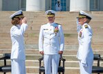 Capt. Lisa Mulligan, left, salutes and relinquishes her command of Naval Medical Center Portsmouth (NMCP) to Capt. Shelley Perkins, right, in front of Rear Adm. Darin Via, Commander, Naval Medical Forces Atlantic, during NMCP’s change of command ceremony.