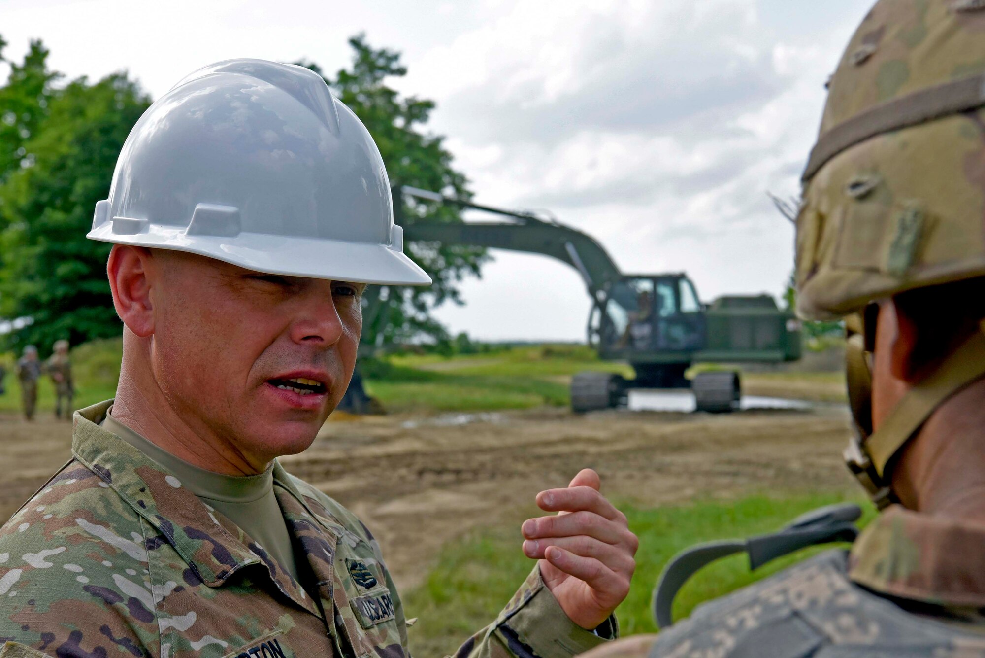 U.S. Army Col. Jon Brierton, Army Support Activity Dix, commander, discusses construction techniques with another solider during the Castle Installation Related Construction exercise on Joint Base McGuire-Dix-Lakehurst, N.J., June 14, 2021. The 668 Engineer Vertical Construction Company out of New Windsor, N.Y., conducted their Reserve Annual Training by overhauling the vehicle training site in preparation for the brand new incoming Joint Light Tactical Vehicles.