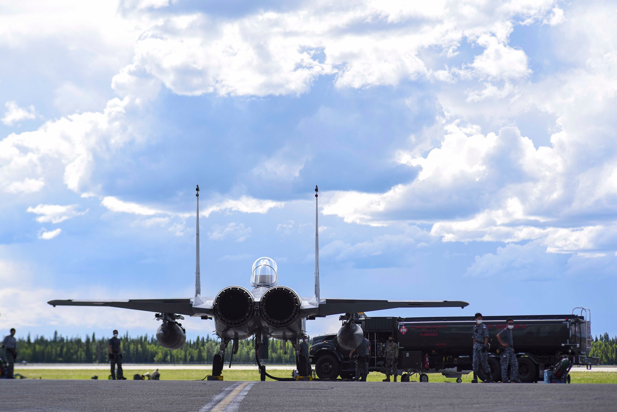 A Koku Jieitai (Japan Air Self-Defense Force) F-15J Eagle deployed from the 9th Air Wing, Naha Air Base, Japan, is refueled by 354th Logistics Readiness Squadron Petroleum, Oil and Lubricants Airmen, and the aircraft maintenance crew, June 8, 2021, on Eielson Air Force Base, Alaska. Allied nations began multilateral training before RED FLAG-Alaska 21-2 to learn the training airspace and operating procedures of the 354th Fighter Wing. (U.S. Air Force photo by Senior Airman Keith Holcomb)