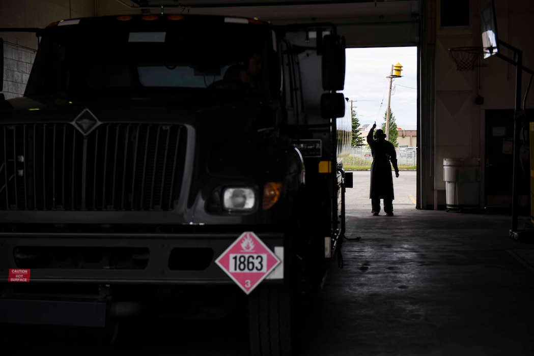 U.S. Senior Airman William Pride, a 354th Logistics Readiness Squadron preventive maintenance journeyman guides a fuel distribution vehicle June 11, 2021, on Eielson Air Force Base, Alaska. The RED FLAG-Alaska 21-2 operations required Petroleum, Oil and Lubricants to distribute to multiple squadrons and allied nations aircraft alongside the 354th Fighter Wing and 168th Wing assets. (U.S. Air Force photo by Senior Airman Keith Holcomb)