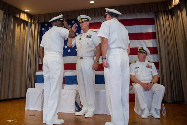 Rear Adm. Brad Collins, new commander, Navy Region Northwest relieves Rear Adm. Stephen Barnett, outgoing commander during a change of command ceremony at Naval Base Kitsap-Bangor June 18.