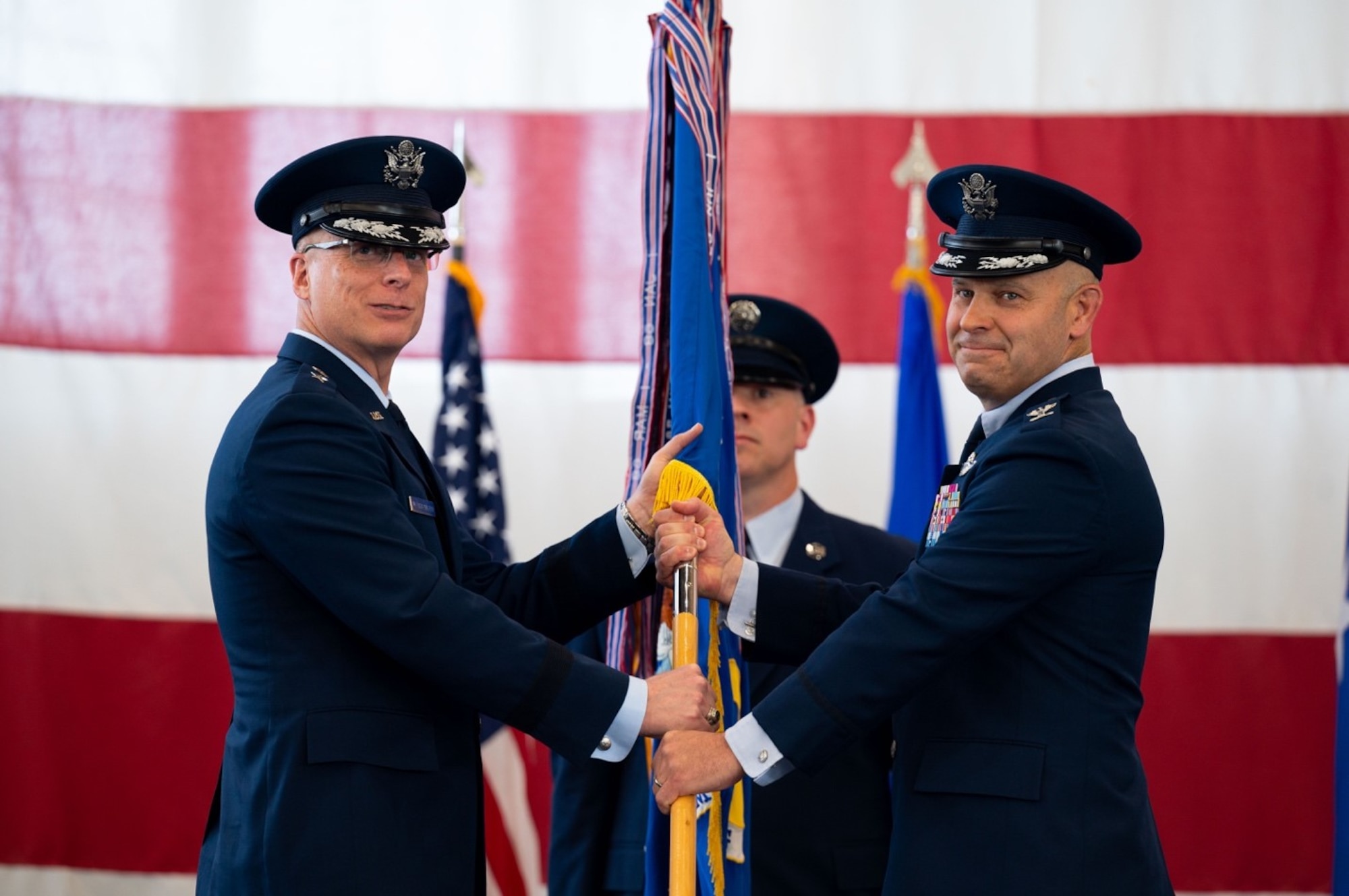 Maj. Gen. Mark E. Weatherington, 8th Air Force and Joint-Global Strike Operations Center commander, presents the guidon of the 28th Bomb Wing to Col. Joseph L. Sheffield, the new 28th BW commander, during a change of command ceremony at Ellsworth Air Force Base, S.D., June 18, 2021.