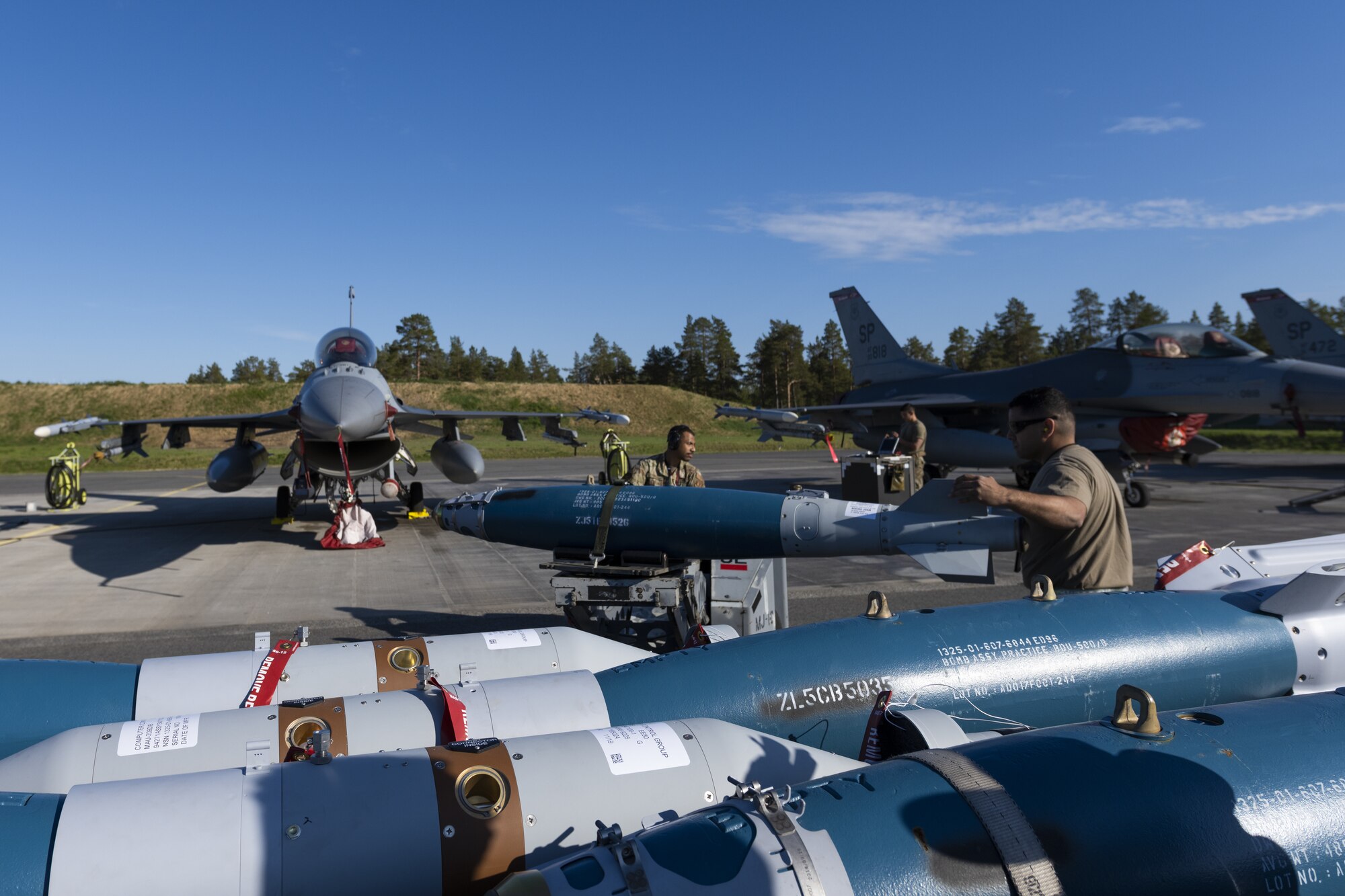 U.S. Air Force Airmen assigned to the 52nd Maintenance Group at Spangdahlem Air Base, Germany, load inert weapons onto F-16 at Kallax Air Base, Sweden, June 8, 2021. Ammo troops assembled GBU-12 bombs, as well as other inert weapons, which were then loaded onto the aircraft for the purpose of training and target practice throughout the Arctic Challenge Exercise 2021. (U.S. Air Force photo by Senior Airman Ali Stewart)