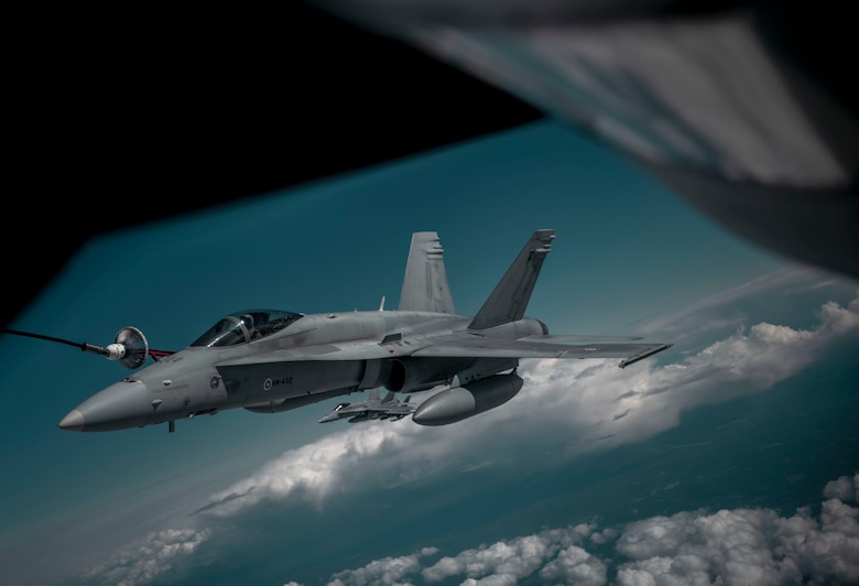 A Finnish air force F-18 Hornet aircraft receives fuel from a U.S. Air Force KC-135 Stratotanker aircraft assigned to the 100th Air Refueling Wing during the Arctic Challenge Exercise 2021 (ACE 21’), over Sweden, June 15, 2021. ACE 21’ is a Royal Norwegian Air Force-led, Nordic large-force, live-fly Field Training Exercise hosted by Norway, Sweden and Finland. (U.S. Air Force photo by Senior Airman Antonia Herrera)