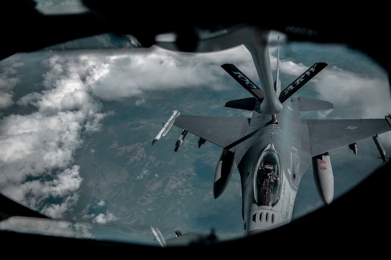 A U.S. Air Force KC-135 Stratotanker aircraft assigned to the 100th Air Refueling Wing at Royal Air Force Mildenhall, England, provides fuel to an F-16 Fighting Falcon aircraft assigned to the 52d Fighter Wing, Spangdahlem Air Base, Germany, above Sweden, June 15, 2021. Agile combat employment exercises enable the 100th ARW to become more agile and responsive to better support European partners and allies. (U.S. Air Force photo by Senior Airman Antonia Herrera)