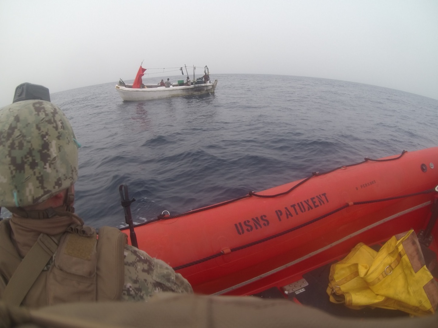 210616-N-NO748-1048 GULF OF ADEN (June 16, 2021) Sailors assigned to Embarked Security Intelligence Team 11, deployed with Commander, Task Force (CTF) 56 and Merchant Mariners from the Military Sealift Command fleet replenishment oiler USNS Patuxent (T-AO 201), approach a vessel in distress during rescue operations in the Gulf of Aden, June 16. Patuxent is deployed to the U.S. 5th Fleet area of operations in support of naval operations to ensure maritime stability and security in the Central Region, connecting the Mediterranean and Pacific through the Western Indian Ocean and three strategic choke points. (U.S. Navy photo)