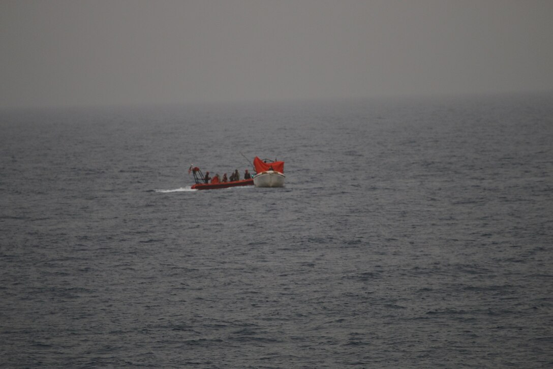 210616-N-NO748-1052 GULF OF ADEN (June 16, 2021) Sailors assigned to Embarked Security  Intelligence Team 11, deployed with Commander, Task Force (CTF) 56 and Merchant Mariners from the Military Sealift Command fleet replenishment oiler USNS Patuxent (T-AO 201), embark mariners from a vessel in distress during rescue operations in the Gulf of Aden, June 16. Patuxent is deployed to the U.S. 5th Fleet area of operations in support of naval operations to ensure maritime stability and security in the Central Region, connecting the Mediterranean and Pacific through the Western Indian Ocean and three strategic choke points. (U.S. Navy photo)