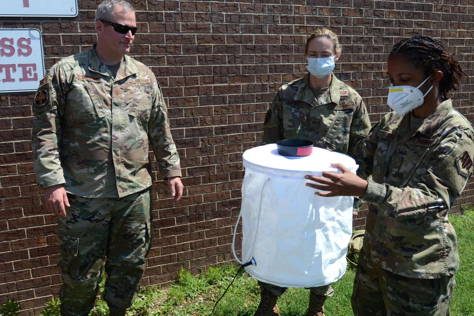 U.S. Air Force Airman 1st Class Sara Thomas, assigned to the 169th Fighter Wing, McEntire Joint National Guard Base, South Carolina, supports Operation Healthy Delta, a Department of Defense sponsored Innovative Readiness Training program designed to provide military training opportunities by providing key services to local citizens. Thomas is inspecting a mosquito trap for vector control at Massac County High School, Metropolis, Illinois June 16, 2021. (U.S. Air National Guard photo by Lt. Col. Jim St.Clair, 169th Fighter Wing Public Affairs)