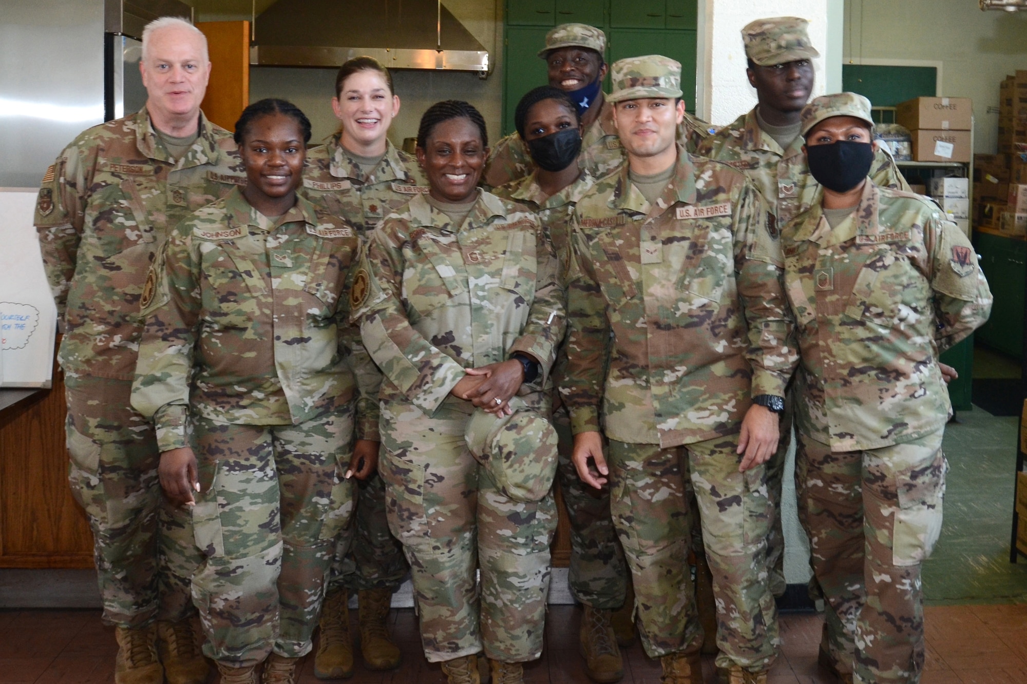 U.S. Air Force Chief Master Sgt. Dayne Peterson (left) and Maj. Rachel Phillips (second from left), assigned to the 169th Fighter Wing, McEntire Joint National Guard Base, South Carolina, visit Operation Healthy Delta, a Department of Defense sponsored Innovative Readiness Training program designed to provide military training opportunities by providing key services to local citizens. Peterson and Phillips pose with members from the 169th Force Support Squadron during operations at Sacred Heart Church in Caruthersville, Missouri June 17, 2021 (U.S. Air National Guard photo by Lt. Col. Jim St.Clair, 169th Fighter Wing Public Affairs)