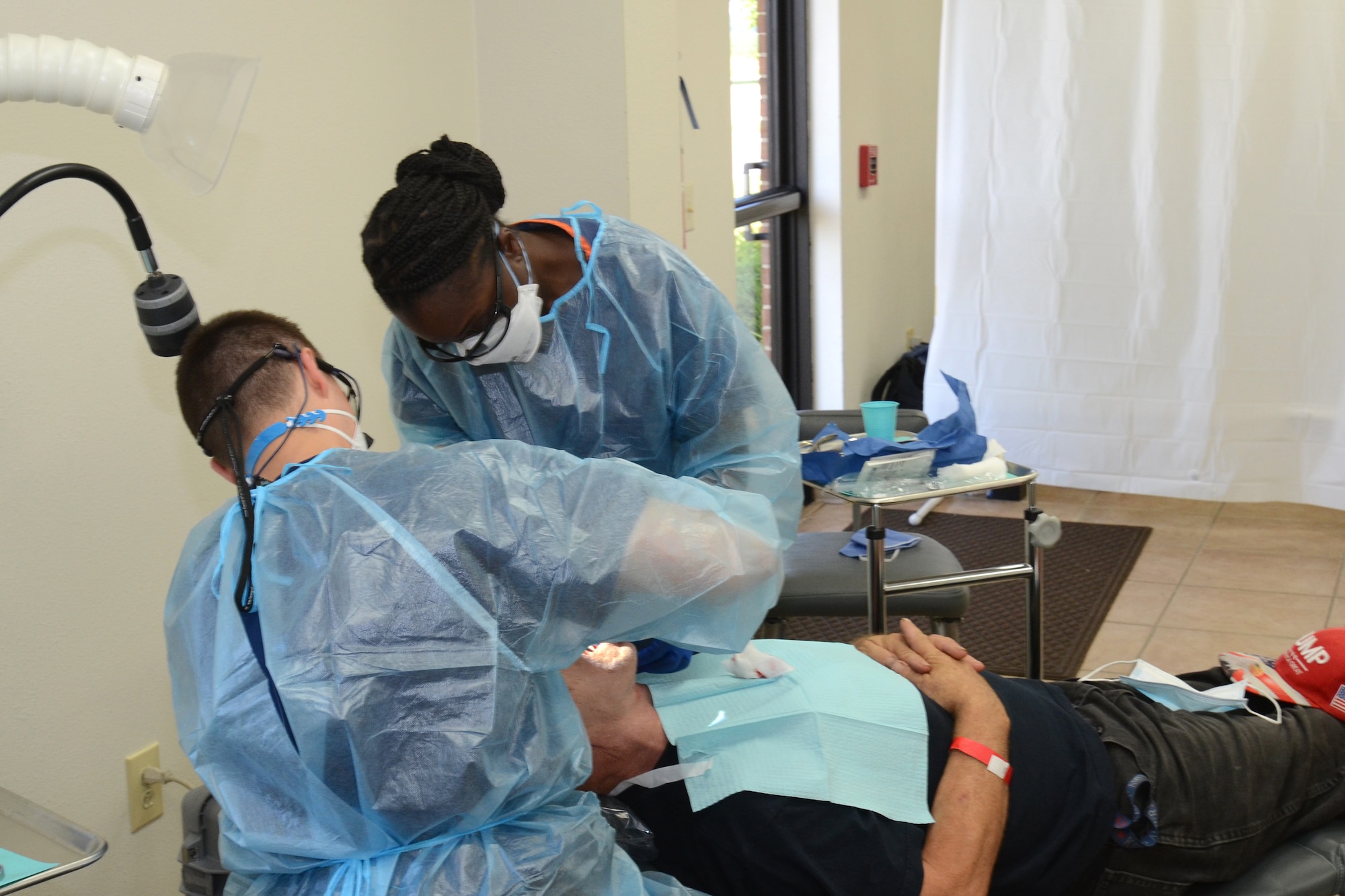 U.S. Air Force Airman 1st Class Julia Coleman, assigned to the 169th Fighter Wing, McEntire Joint National Guard Base, South Carolina, supports Operation Healthy Delta, a Department of Defense sponsored Innovative Readiness Training program designed to provide military training opportunities by providing key services to local citizens. Coleman is a dental technician assisting during a procedure at Miner Baptist Church, Sikeston Missouri June 17, 2021. (U.S. Air National Guard photo by Lt. Col. Jim St.Clair, 169th Fighter Wing Public Affairs)