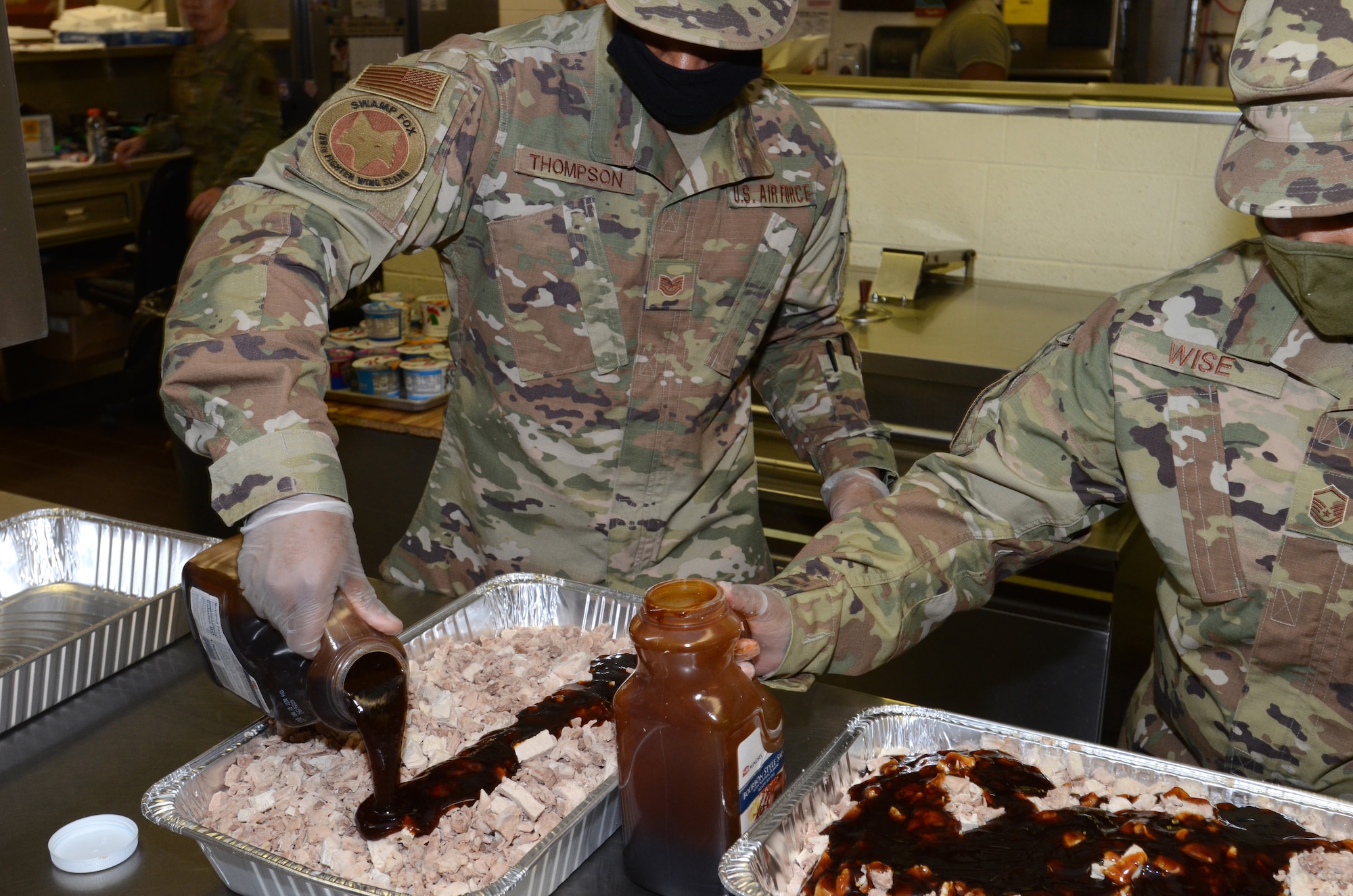 U.S. Air Force Tech. Sgt. Douglas Thompson and Master Sgt. Katina Wise, assigned to the 169th Fighter Wing, McEntire Joint National Guard Base, South Carolina, support Operation Healthy Delta, a Department of Defense sponsored Innovative Readiness Training program designed to provide military training opportunities by providing key services to local citizens. They are preparing the evening meal for military members working at Massac County High School, Metropolis, Illinois June 16, 2021. (U.S. Air National Guard photo by Lt. Col. Jim St.Clair, 169th Fighter Wing Public Affairs)