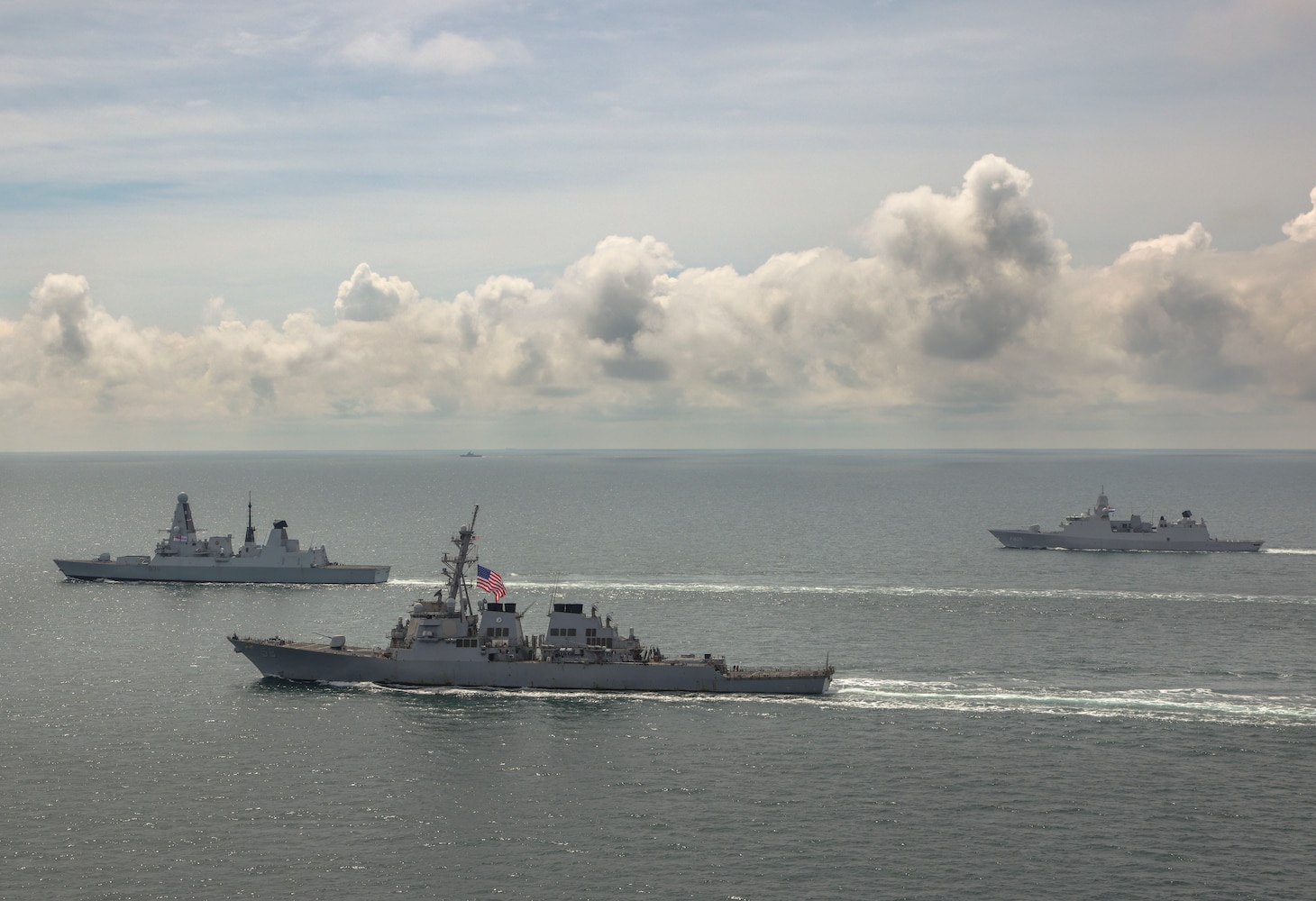 BLACK SEA (June 17, 2021) HMS Defender, USS Laboon and HMNLS Evertsen take station for close proximity sailing as a Russian warship watches from afar (rear of picture) whilst on maritime operations in the Black Sea. On Thursday 17th June 2021, HMS Defender conducted close proximity sailing with allied warships HMNLS Evertsen and USS Laboon whilst operating in the Black Sea, east of the Mediterranean.The ships have been working closely with each other honing various communication skills and navigation exercises.The close proximity sailing often referred to as a SCREENEX is the culmination of the last few days of serials formulating into one final exercise. (LPhot Dan Rosenbaum, HMS Defender)