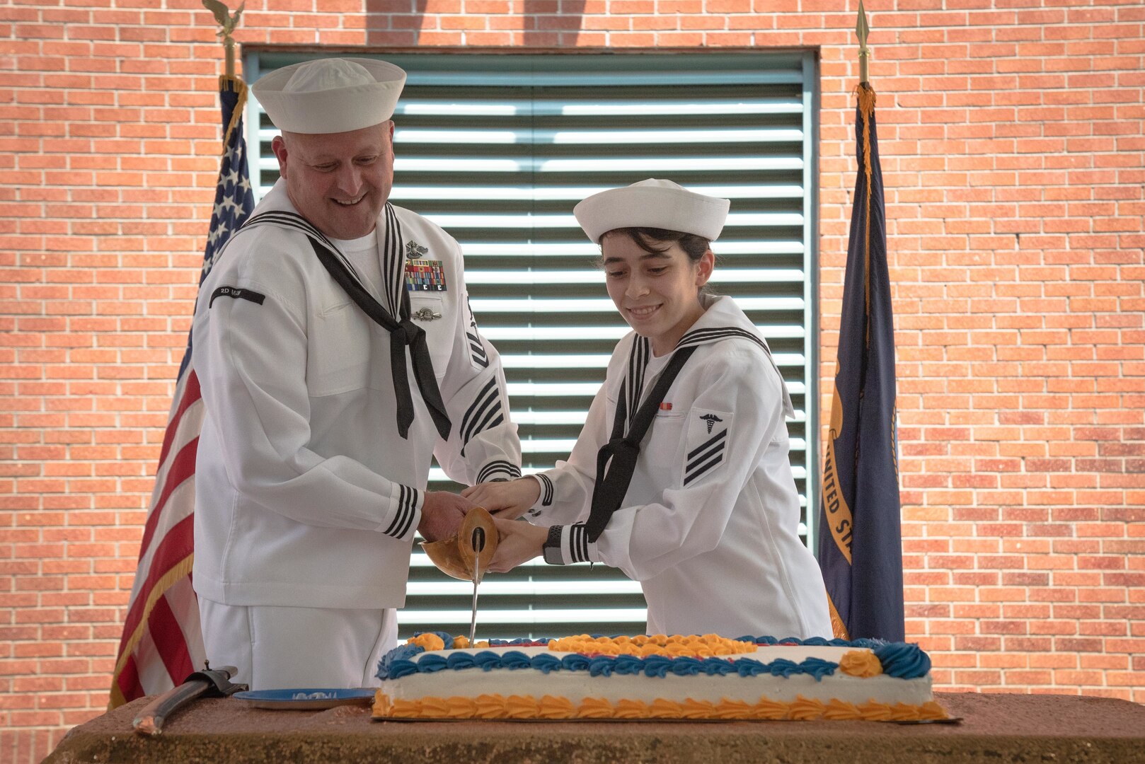 Petty Officer 1st Class Jeremy Mullen, left, and Seaman Jaleana Turcotte, right, the oldest and youngest Corpsman serving aboard Naval Health Clinic Cherry Point, cut a specially made cake during a ceremony honoring the 123rd anniversary of the establishment of the U.S. Navy Hospital Corps held Thursday, June 17, 2021 aboard Marine Corps Air Station Cherry Point.