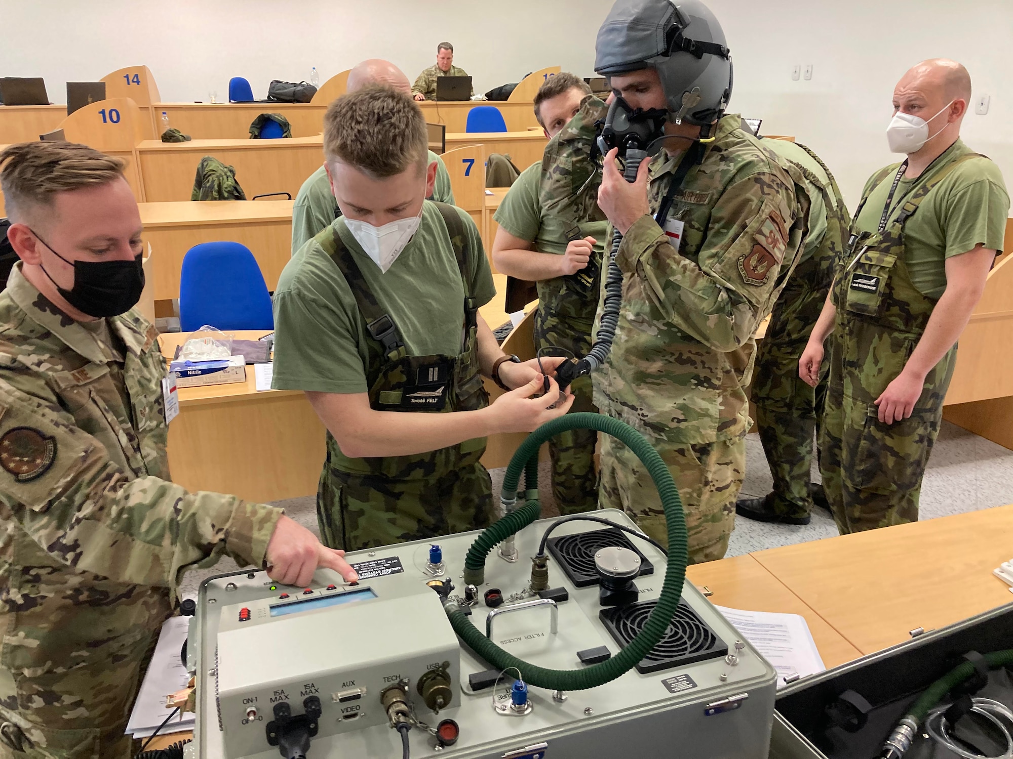An Airman teaches the Czechian AF about joint aircrew system testers.