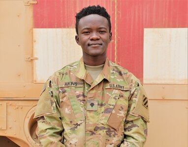 Georgia Army National Guard Spc. Reginald Aikins, a medic, stands in front of a field litter ambulance during exercise African Lion 21 June 15, 2021, in Tan-Tan, Morocco. African Lion 2021 is U.S. Africa Command's largest annual exercise, hosted by Morocco, Tunisia and Senegal June 7-18. Aikins grew up in Ghana and immigrated to the United States in 2013.