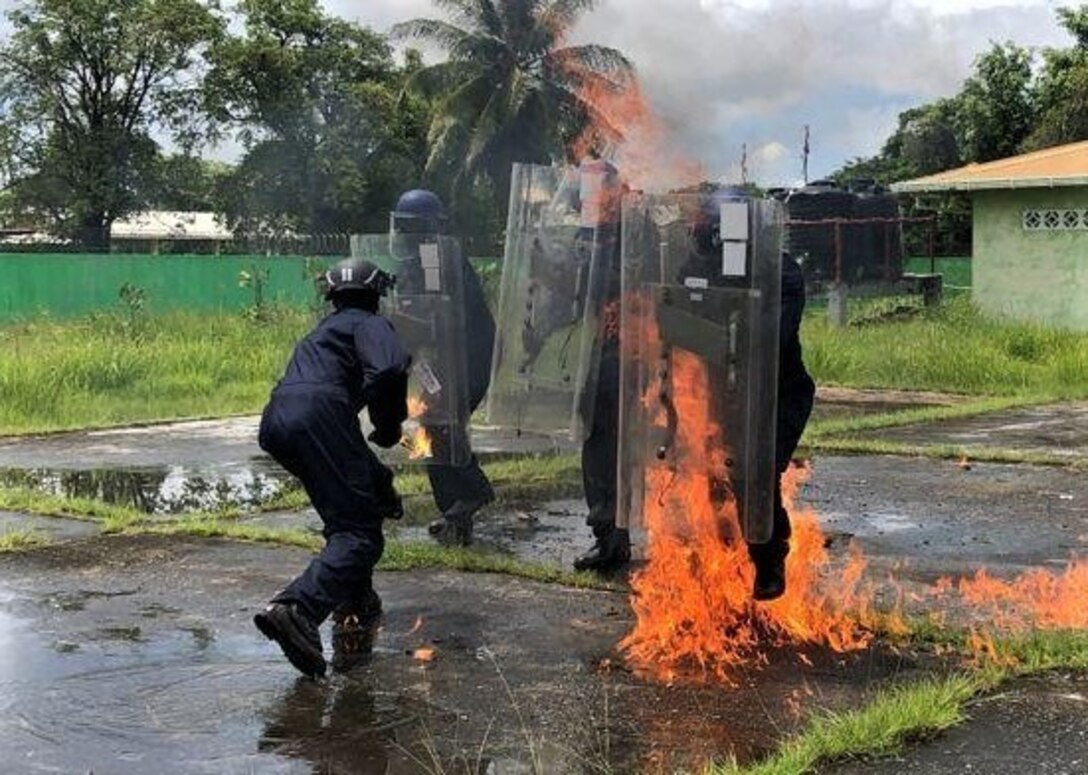 A Guyanese Police Force cadet as they undergoes petrol bomb training.
