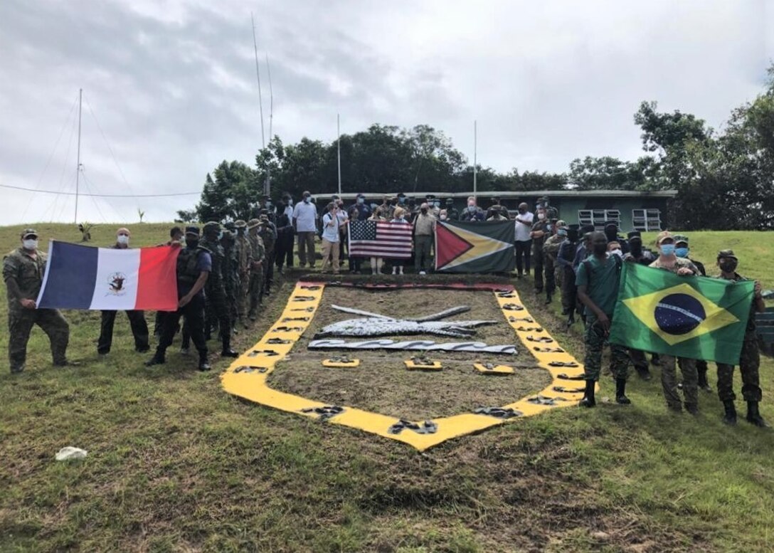 Participants from several countries pose for a photo at the Colonel Robert Mitchell Jungle and Amphibious Training School.