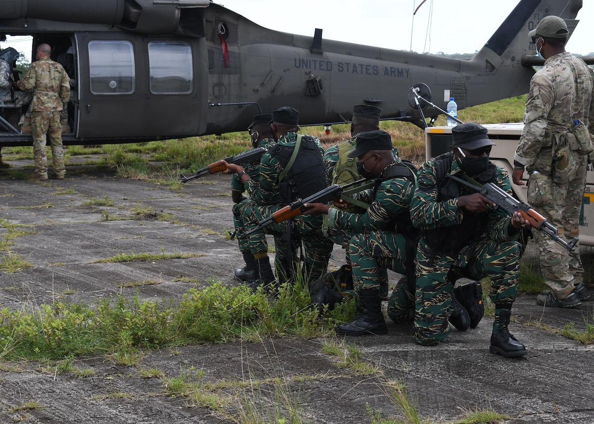 Members of the Guyana Defence Force, along with members from the Florida National Guard, 1-185th Assault Helicopter Battalion, Brooksville, Fla., participate in cold load drills.