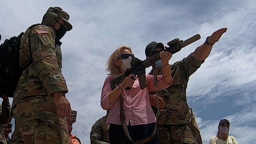 A U.S. Soldier with 7th Special Forces Group instructs U.S. Ambassador to the Co-operative Republic of Guyana, Sarah-Ann Lynch, on marksmanship skills during Tradewinds 2021.