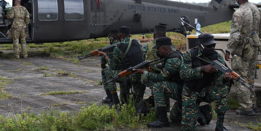 Members of the Guyana Defence Force, along with members from the Florida National Guard, 1-185th Assault Helicopter Battalion, Brooksville, Fla., participate in cold load drills.
