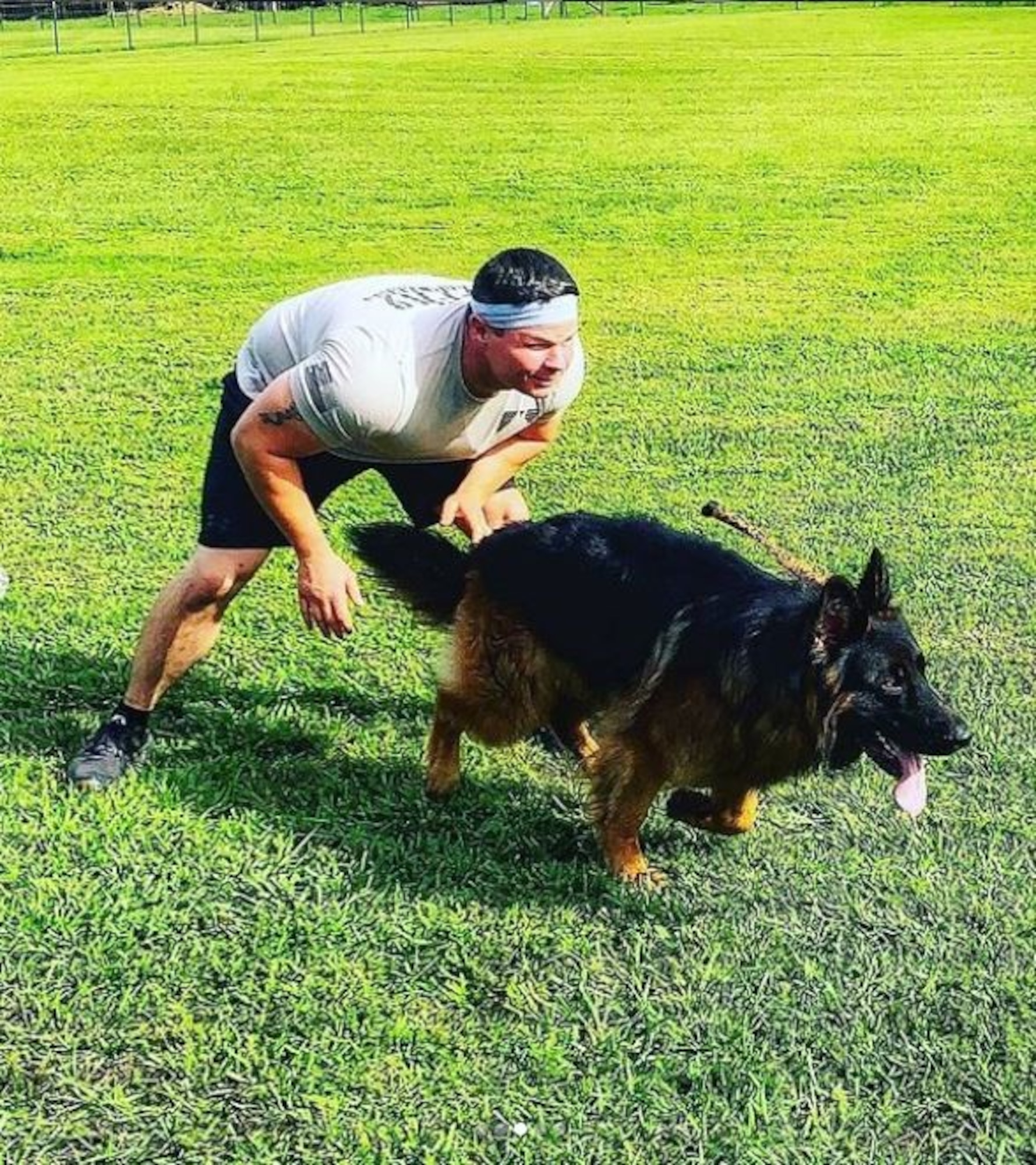 U.S. Air Force Tech. Sgt. William Kuryluk, 609th Expeditionary Communications Squadron, noncommissioned officer in charge of Radio Frequency Transmissions section with his Western Long Coat German Shepherd, Bishop, during an outdoor fitness session. Kuryluk integrated his three-year-old dog into his personal fitness plan when gym access became limited due to COVID-19. (Courtesy Photo)