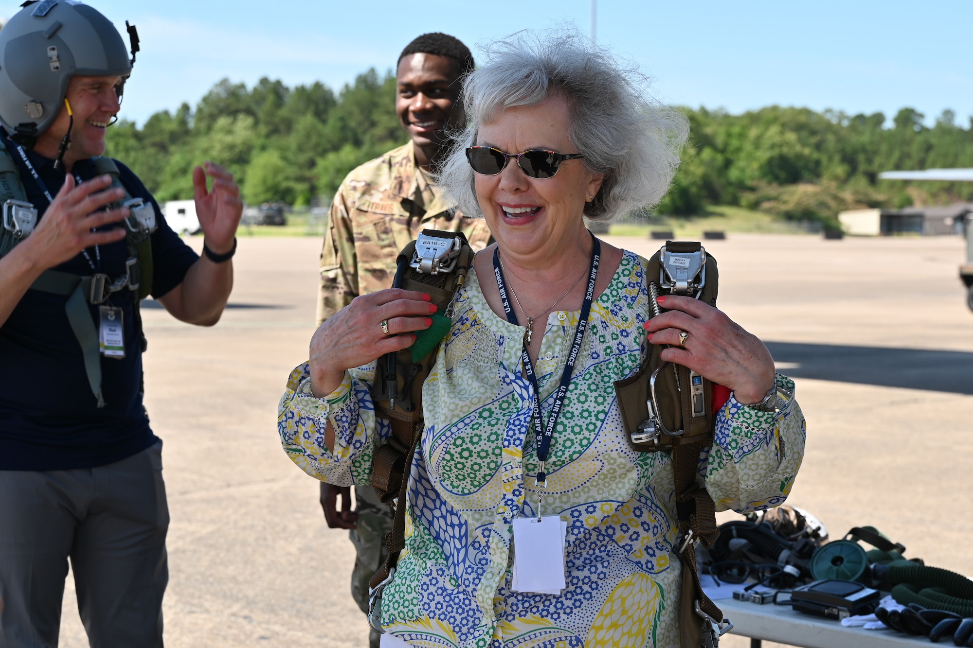 Linda Inman, Air Mobility Command Civic Leader representing Grand Forks Air Force Base, North Dakota tries on a parachute