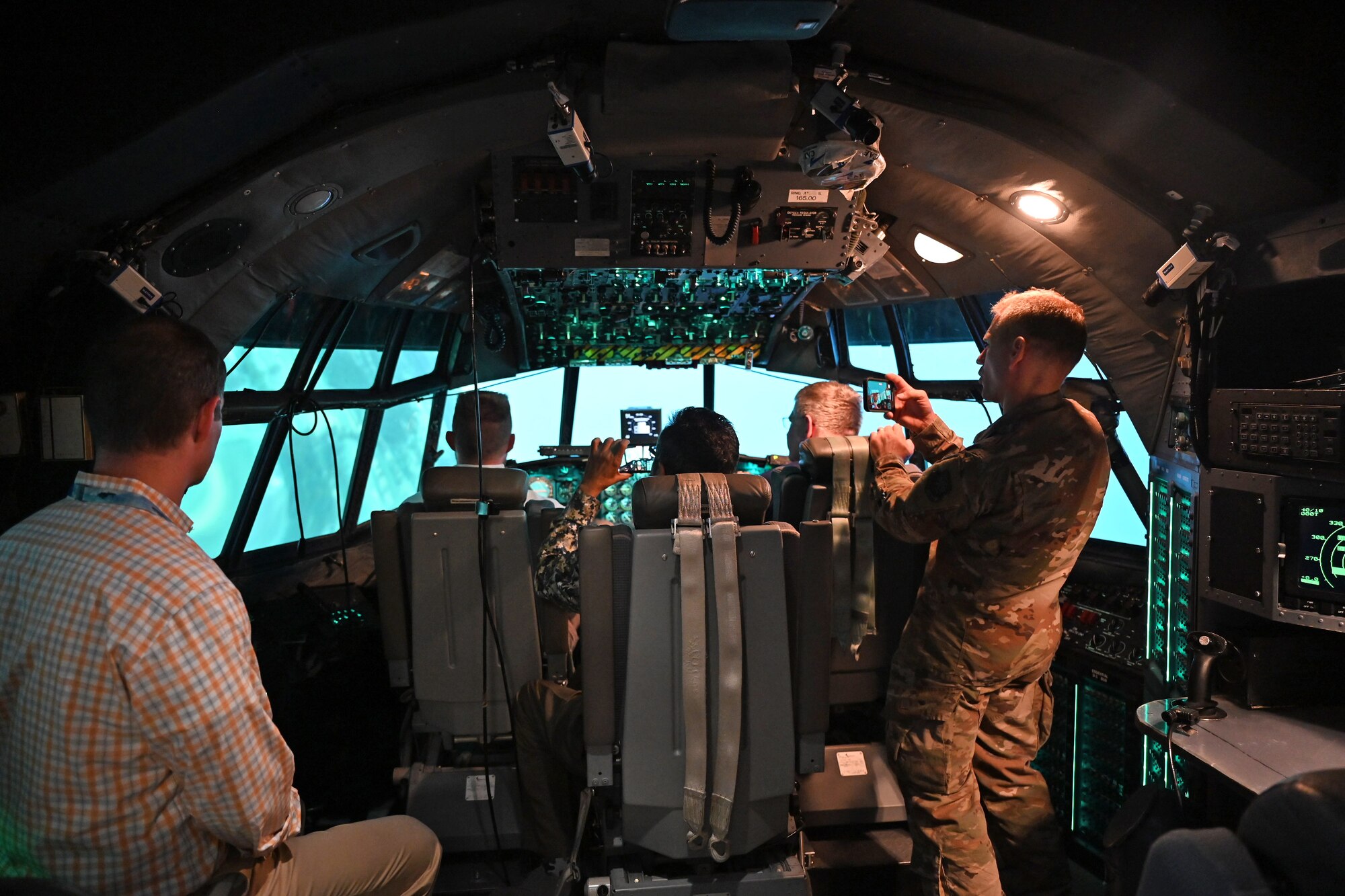 Air Mobility Command Civic Leaders fly in a C-130 Hercules simulator