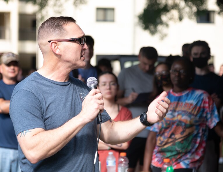 Chief Master Sgt. Travis Chadick, 2nd Bomb Wing command chief, makes remarks during a campus clean-up at Barksdale Air Force Base, Louisiana, June 12, 2021. Dorm residents and senior leadership worked together to clean the Barksdale campus. (U.S. Air Force photo by Airman 1st Class William Pugh)