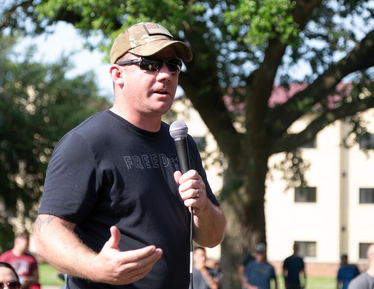 Master Sgt. Dustin Holmes, 2nd Civil Engineer Squadron superintendent of unaccompanied housing, makes remarks during a campus clean-up at Barksdale Air Force Base, Louisiana, June 12, 2021. The clean-up efforts provided dorm residents the opportunity to learn from and connect with their senior leadership. (U.S. Air Force photo by Airman 1st Class William Pugh)