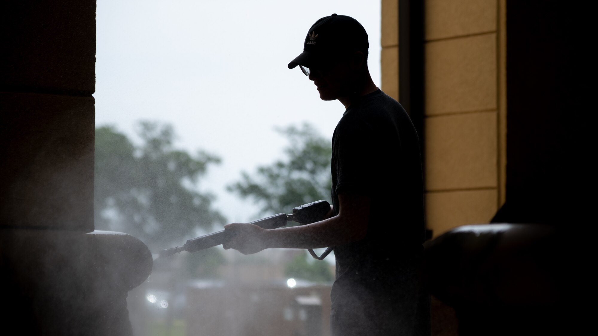 A Barksdale Airman pressure washes one of the dorm buildings during a campus clean-up at Barksdale Air Force Base, Louisiana, June 12, 2021. The clean-up efforts provided dorm residents the opportunity to learn from and connect with their senior leadership. (U.S. Air Force photo by Airman 1st Class William Pugh)