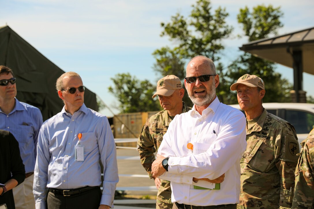 Geoff Odlum (right), an exercise support contractor, briefs as a foreign service officer during the Rehearsal of Concept drill at Command Post Exercise – Functional (CPX-F) 21-02 at Ft. McCoy, Wis., June 5, 2021. As a contracted role player, Odlum adds a layer of detailed coordination and realism to the exercise that troops are seldom able to replicate at home station.