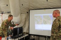 U.S. Army Reserve Spc. Zachary H. Bendorf, psychological operations specialist, 11th Psychological Operations Battalion, briefs Brig. Gen. Jeffrey C. Coggin, commanding general, U.S. Army Civil Affairs and Psychological Operations Command (Airborne), using the Command Post of the Future (CPOF) platform. Bendorf is able to brief the commanding general on battlefield topsight, collaboration and live data using this system at Command Post Exercise – Functional (CPX-F) at Fort McCoy, Wis., June 10, 2021.