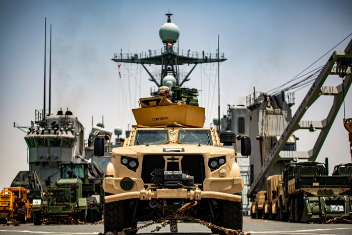 A Marine in a joint light tactical vehicle, assigned to the 24th Marine Expeditionary Unit, provides rear security aboard dock landing ship USS Carter Hall (LSD 50) while transiting the Suez Canal, June 1. The Iwo Jima Amphibious Ready Group and the 24th Marine Expeditionary Unit are deployed to the U.S. 5th Fleet area of operations in support of naval operations to ensure maritime stability and security in the Central Region, connecting the Mediterranean and Pacific through the western Indian Ocean and three strategic choke points.