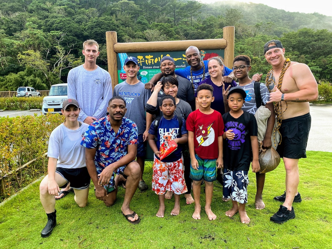 U.S. Marines, Sailors, civilians and their families pose for a photo after surviving a flash flood at Ta-Taki Falls, Okinawa, Japan, Sept. 13, 2020. The members of the group found themselves in a life-threatening situation and assisted each other and local nationals to return safely.