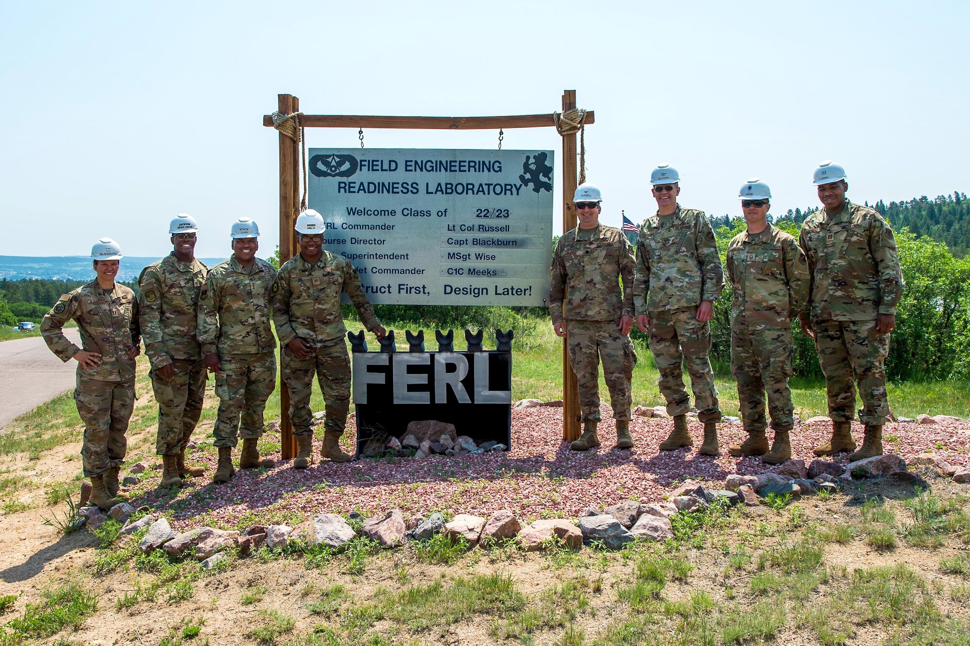 Lieutenant Gen. Richard Clark, superintendent of the Air Force Academy (third from left), poses for a photograph with civil engineering staff and cadets at the school’s field engineering readiness lab in Jack’s Valley