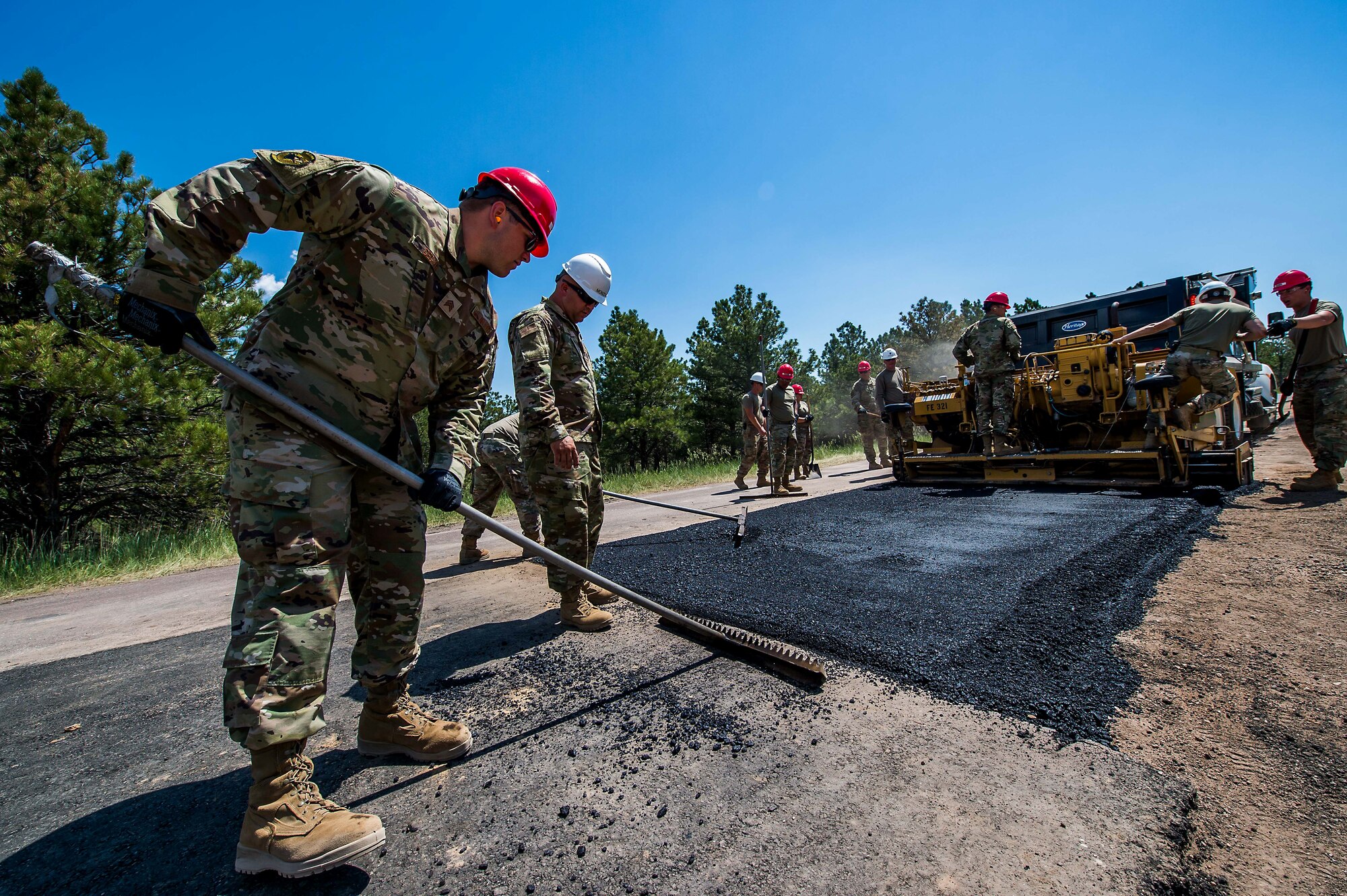 Cadets at the U.S. Air Force Academy and their civil engineering mentors pave a stretch of road in Jack's Valley