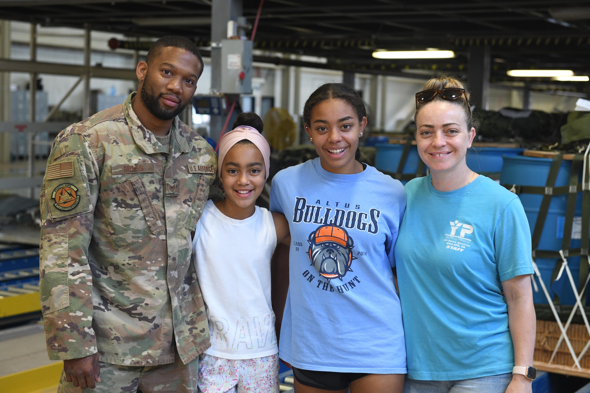 airman poses with family