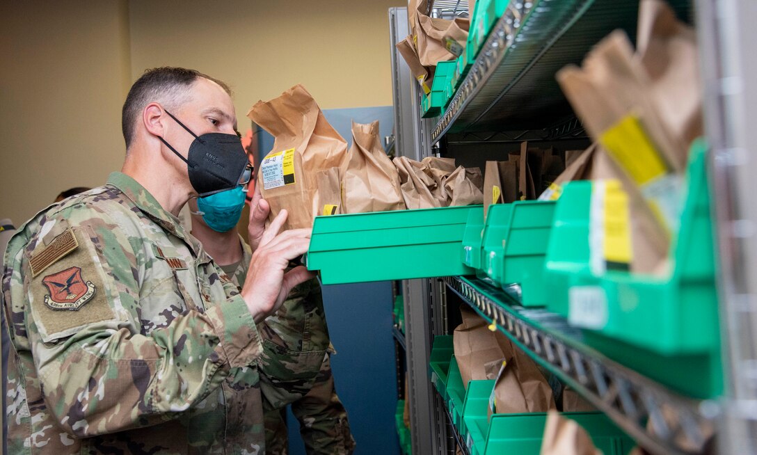 Col. Matt Husemann, 436th Airlift Wing commander, looks for a prescription during a 436th Medical Group immersion at Dover Air Force Base, Delaware, June 17, 2021. The immersion gave Husemann hands-on experience of 436th MDG operations. (U.S. Air Force photo by Tech. Sgt. Nicole Leidholm)