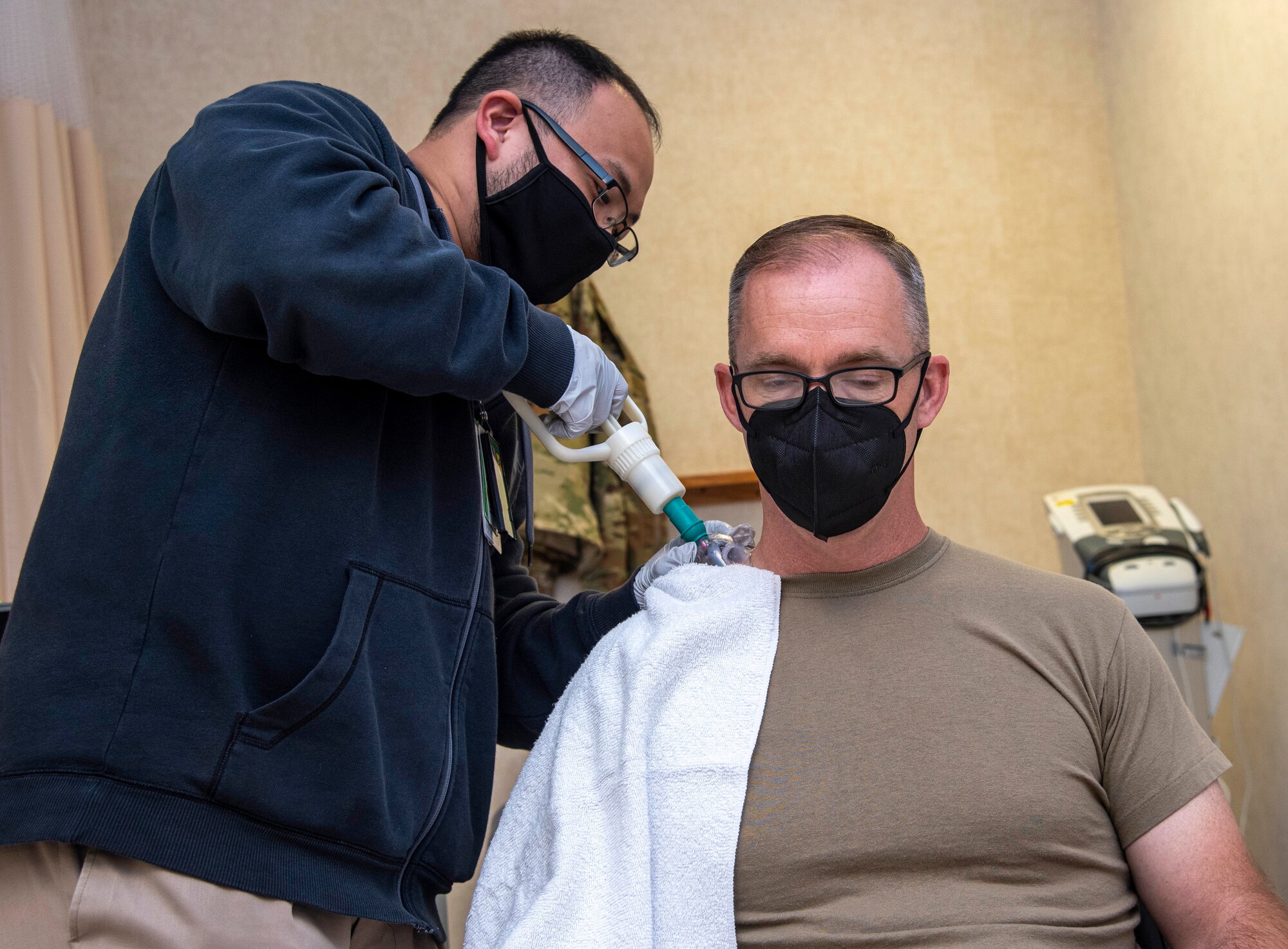 Lee Applequist, left, 436th Health Care Operations Squadron physical therapist, performs cupping therapy on Chief Master Sgt. Timothy Bayes, 436th Airlift Wing command chief, during a 436th Medical Group immersion at Dover Air Force Base, Delaware, June 17, 2021. The immersion gave Bayes hands-on experience of 436th MDG operations. (U.S. Air Force photo by Tech. Sgt. Nicole Leidholm)