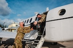 Rhode Island National Guard (RING) crewmembers load specialized coolers filled with COVID-19 vaccine doses onto a RING C-12 aircraft for distribution to the Family Islands in The Bahamas, June 21, 2021.